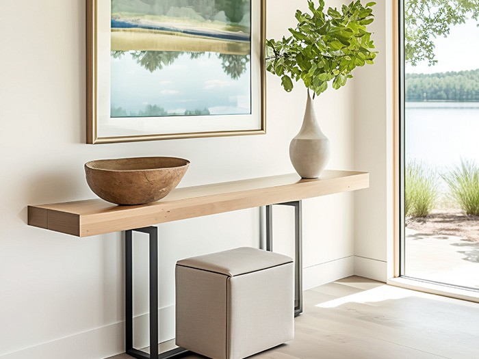 Modern wooden table with rustic vase and bowl with contemporary nature framed art hanging right above.